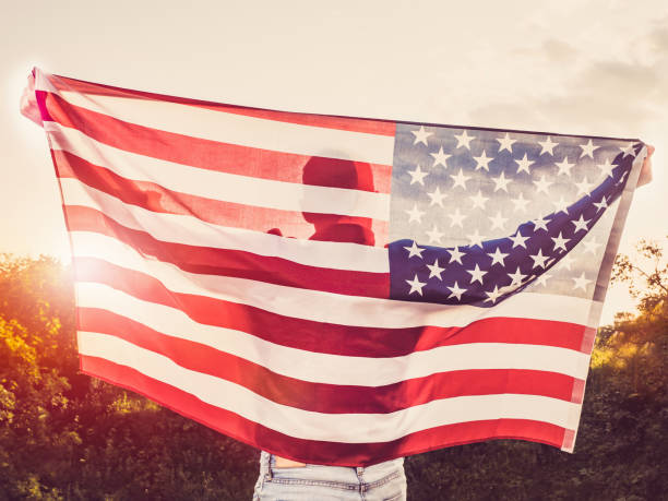 istock Handsome, young man waving an American flag 1147128372