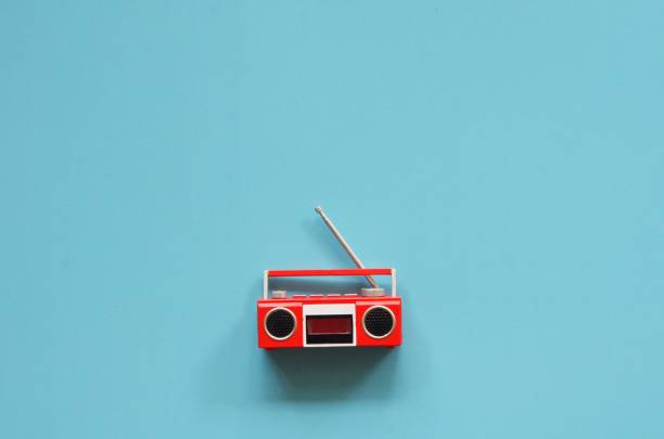 Flat lay vintage radio over blue background.