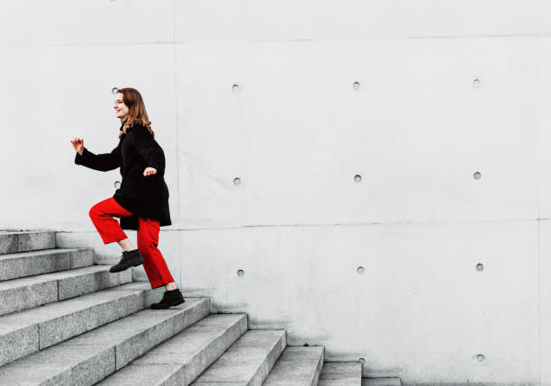 istock Woman climbing up the stairs 1147129627