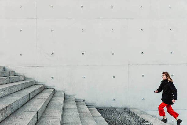 istock Woman climbing up the stairs 1147129714