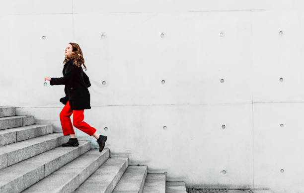 istock Woman climbing up the stairs 1147129928