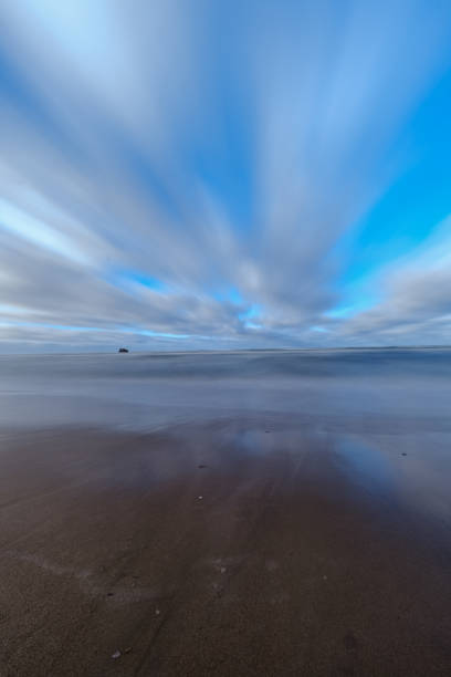 istock sea beach with sand and water in sunny day 1147129957