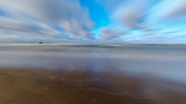istock sea beach with sand and water in sunny day 1147129974