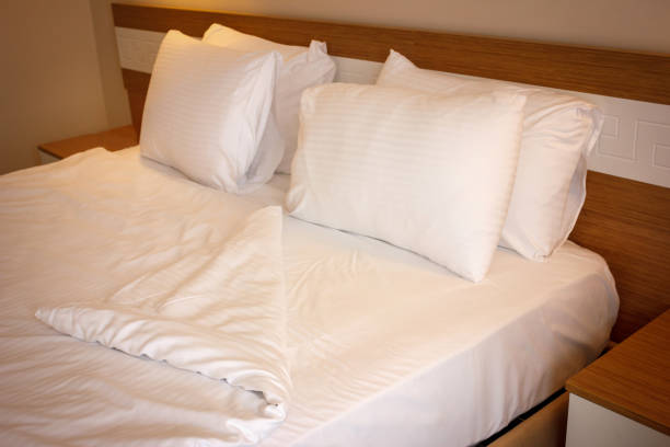 istock Double bed with white linens, prepared for bedtime sleeping 1147131537
