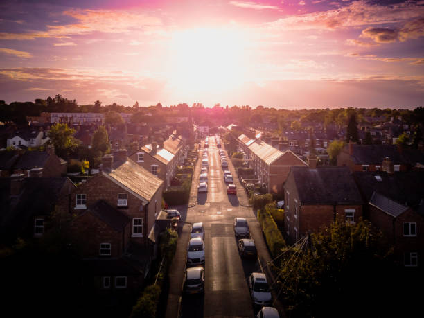 istock Sun setting with atmospheric effect over traditional British houses and tree lined streets. 1147131602