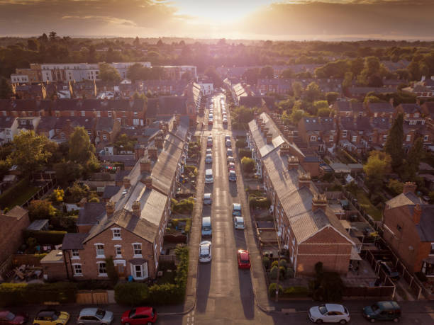istock Sun setting with atmospheric effect over traditional British houses and tree lined streets. 1147131608