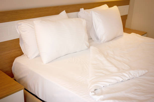 istock Double bed with white linens, prepared for bedtime sleeping 1147131658