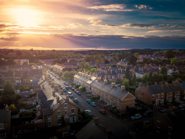 istock Sun setting with atmospheric effect over traditional British houses and tree lined streets. 1147131692