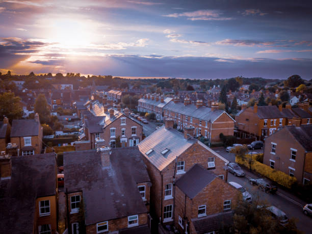 istock Sun setting with atmospheric effect over traditional British houses and tree lined streets. 1147131732