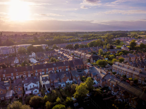 istock Sun setting with atmospheric effect over traditional British houses and tree lined streets. 1147131736