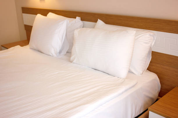 istock Double bed with white linens, prepared for bedtime sleeping 1147131795