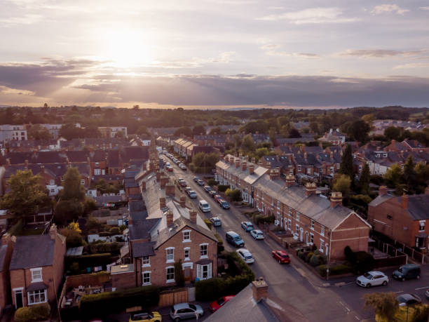 istock Sun setting with atmospheric effect over traditional British houses and tree lined streets. 1147131867