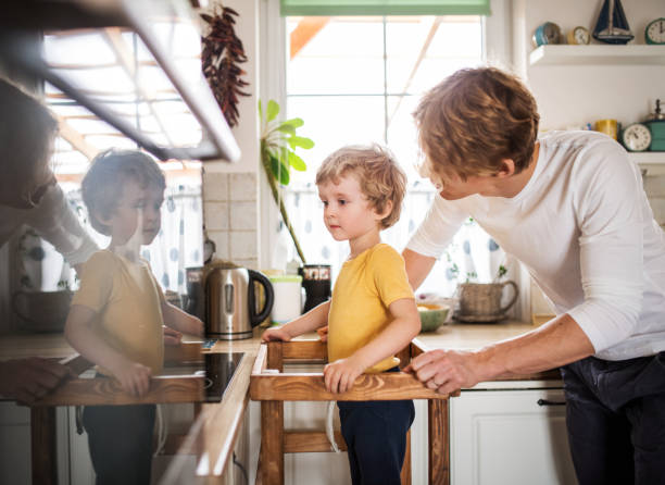 istock A young father with a toddler son in a kitchen at home. 1147134773