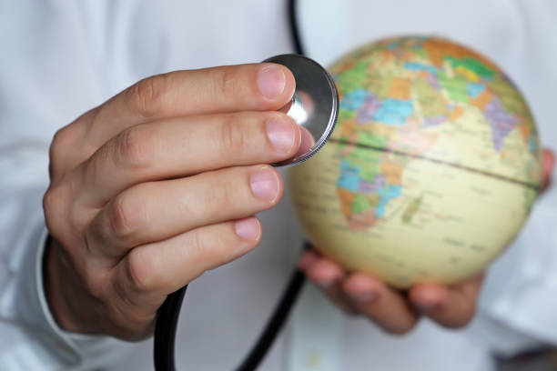 istock Doctor with stethoscope and a globe in his hands 1147135875