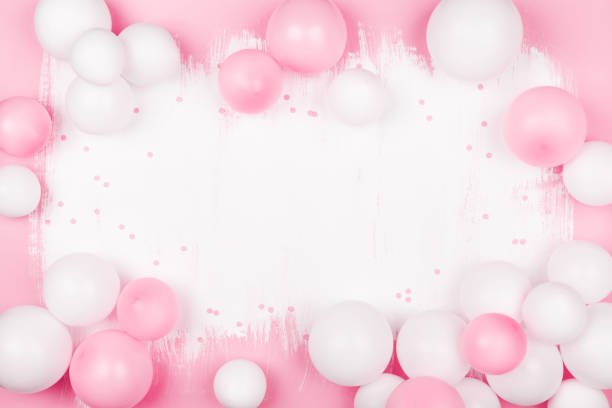 istock Creative painted background with white pink balloons and confetti. Top view and flat lay. Birthday or party concept. 1147139114