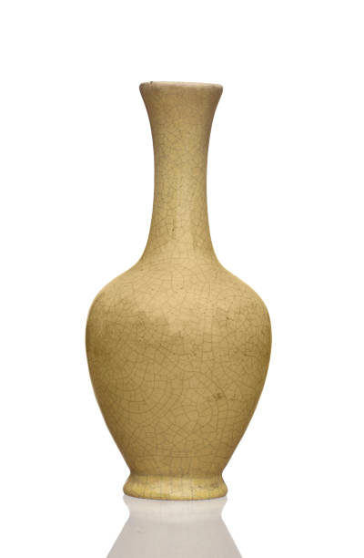 istock Old pale yellow crackle glaze vase isolated on white background. 1147140398