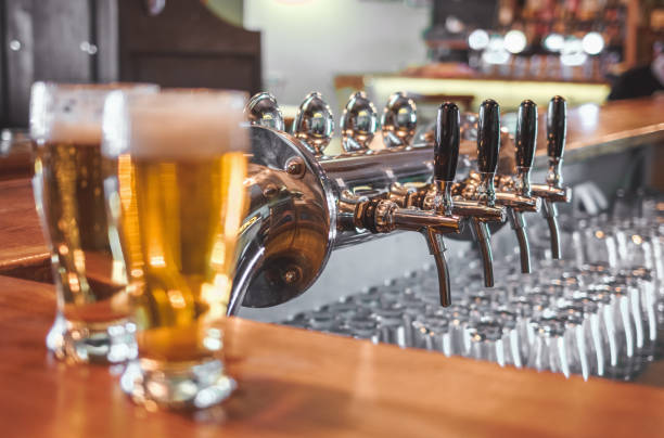 istock Drinking Craft Beer. Two Glasses of Beer on a bar table. 1147140909