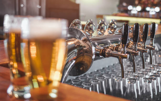 istock Drinking Craft Beer. Two Glasses of Beer on a bar table. 1147141072