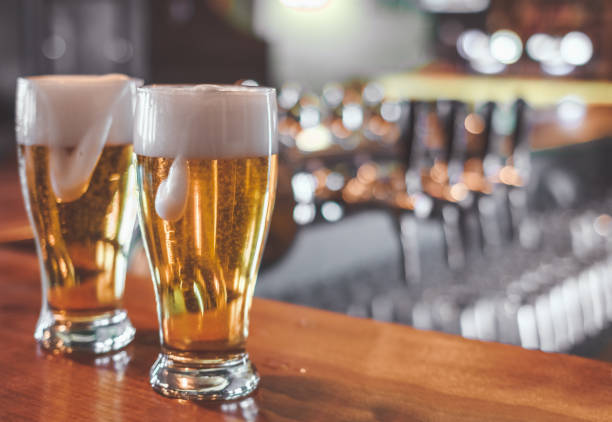 istock Drinking Craft Beer. Two Glasses of Beer on a bar table. 1147141089