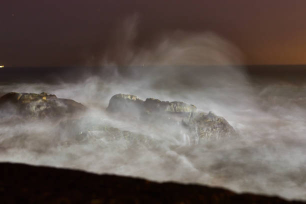 Stormy weather and breaking waves at night in Atlantic ocean