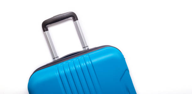 istock Blue suitcase on white background Creative Summer holidays, vacation, travel concept Banner 1147153891