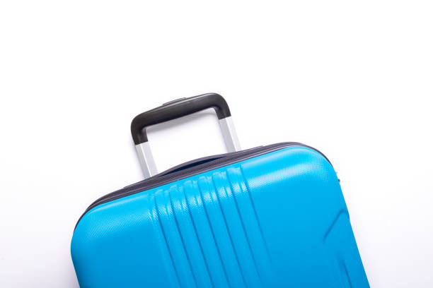istock Blue suitcase on white background Creative Summer holidays, vacation, travel concept Banner 1147154396