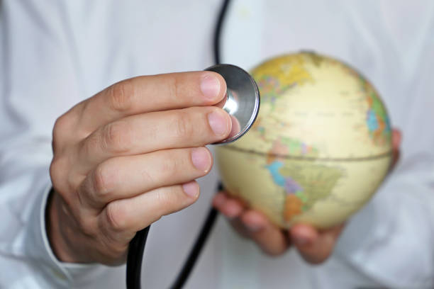 Doctor with stethoscope and globe in his hands Medical network and health care in US, North and South America, concept of world medicine, international Medical Worker Day population explosion photos stock pictures, royalty-free photos & images