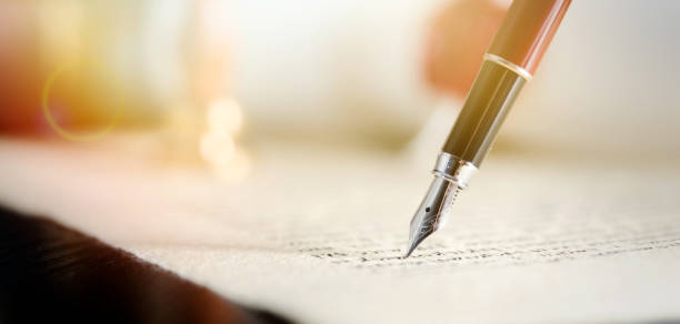 Notary or attorney signs legal contract Notary signs legal contract. Close up of fountain pen on paper notary photos stock pictures, royalty-free photos & images