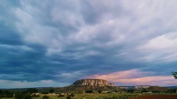 A beautiful scenery as the rain clouds form into pink and blue arrays. Zuni Pueblo Mountain; Dowa Yallane