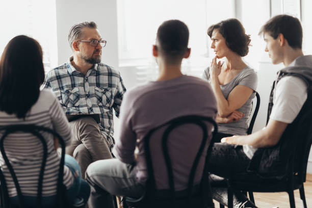 Woman talking to professional psychotherapist in support group for ACOA