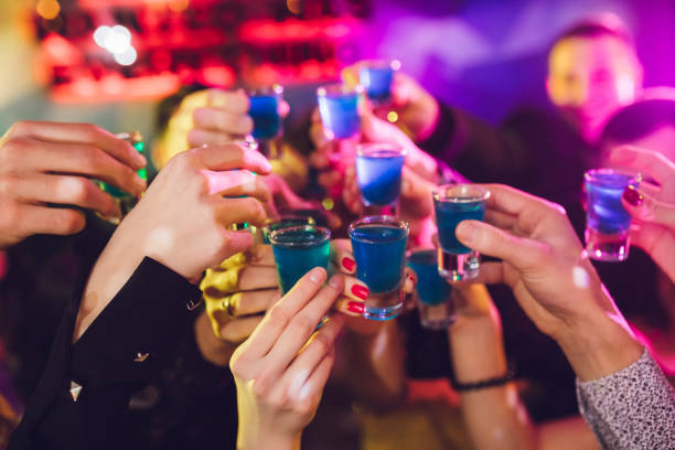 Shooter toast Group of people celebrating new year at a party shot glass stock pictures, royalty-free photos & images