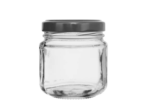 istock empty glass jar for jam closed by a black metal cover isolated on a white background 1147163687