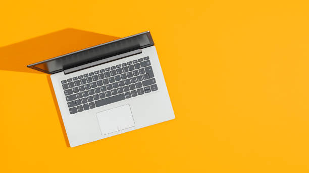 istock Laptop on a bright yellow desk 1147170508