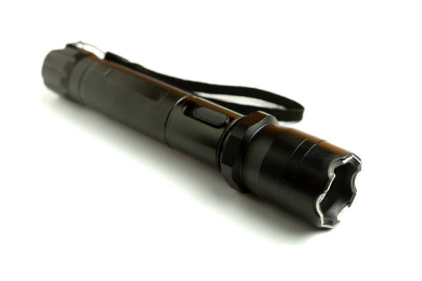 istock A black metal flashlight with shocker at the white background. protection and security concept. for design and decoration. 1147171611