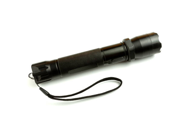 istock A black metal flashlight with shocker at the white background. protection and security concept. for design and decoration. 1147172128