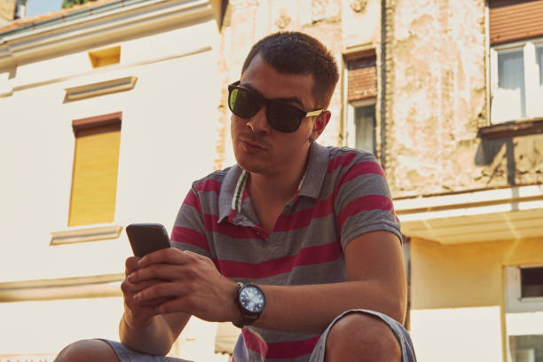 istock Young attractive man using cellphone outdoors. 1147172165