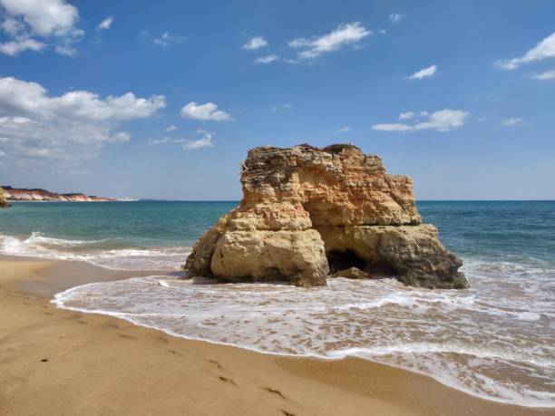 Natural rock on Albufeira water's edge. stock photo