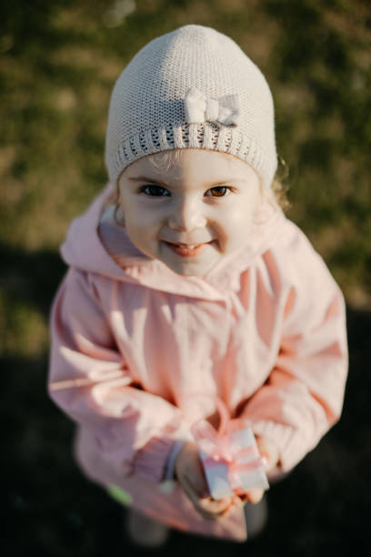 istock Little Girl Showing Gift Box 1147176228