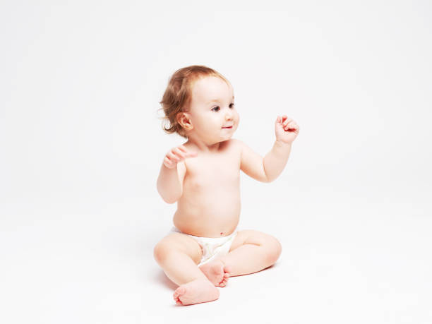 istock Cute baby sitting on white background 1147185834