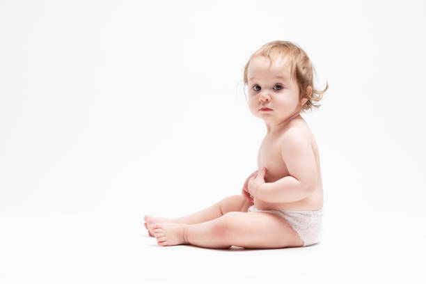 Cute baby sitting on white background.