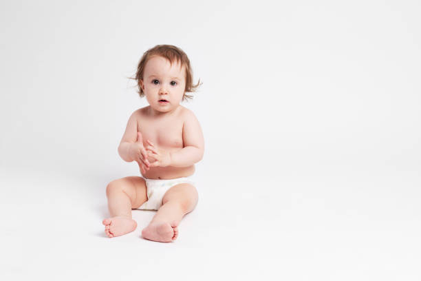 istock Cute baby sitting on white background 1147185964