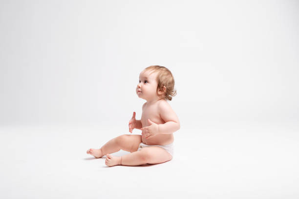 istock Cute baby sitting on white background 1147185965