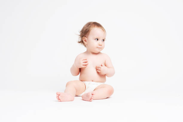 istock Cute baby sitting on white background 1147185994