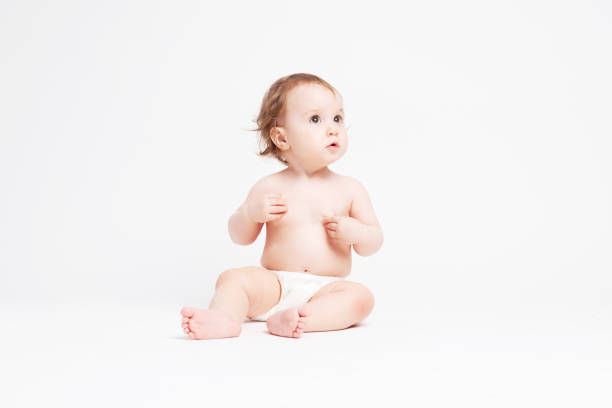 istock Cute baby sitting on white background 1147187308