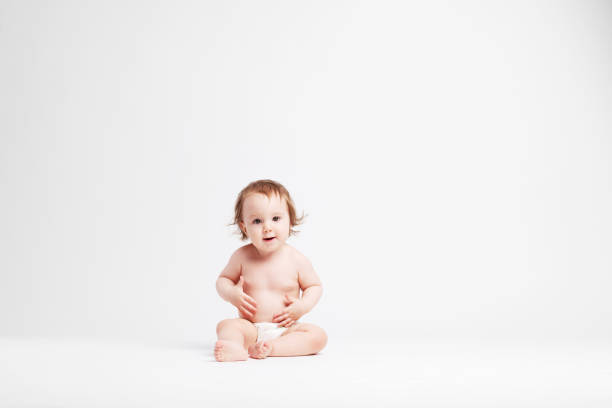 istock Cute baby sitting on white background 1147187347