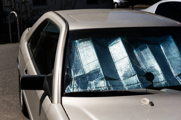 o carro estacionado com refletor de sun mantem a luz & heat nosso do interior - rear view mirror car mirror sun - fotografias e filmes do acervo