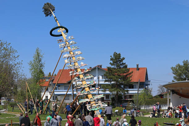 Fluttering colored satin ribbons on Maypole against sky background. Celebrating Summer Solstice and Kupala Night Holiday or Ivan-Kupala. Selective focus