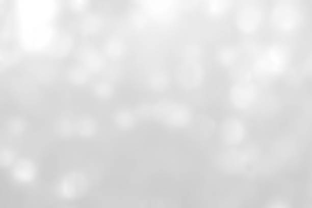 istock Blur abstract background silver bright sparkling white light glittering bokeh illumination 1147194555