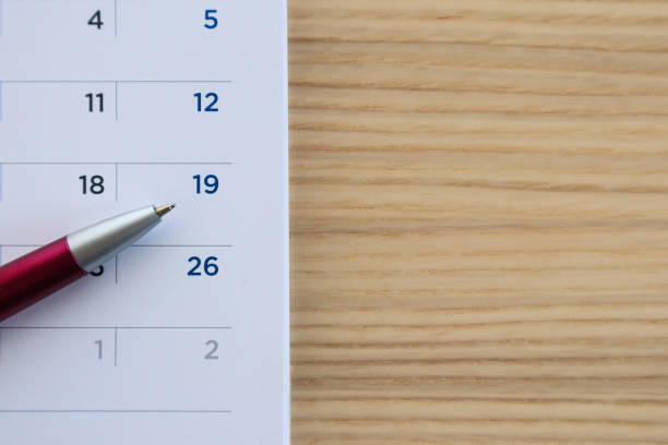 istock calendar page on wood table background with pen point at 19th date 1147196601