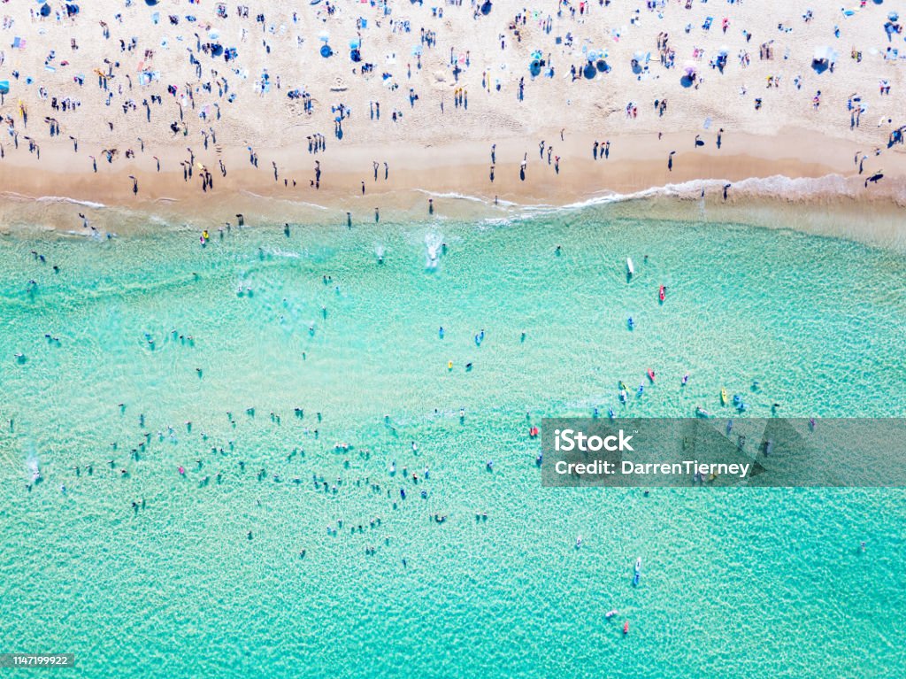 An aerial view of people at the beach An aerial view looking down at Bondi Beach in Sydney on a busy day with blue water Bondi Beach Stock Photo